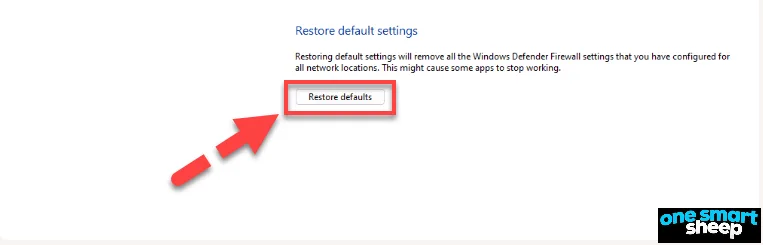 Windows Restore default settings page with a red arrow pointing to the Restore defaults button