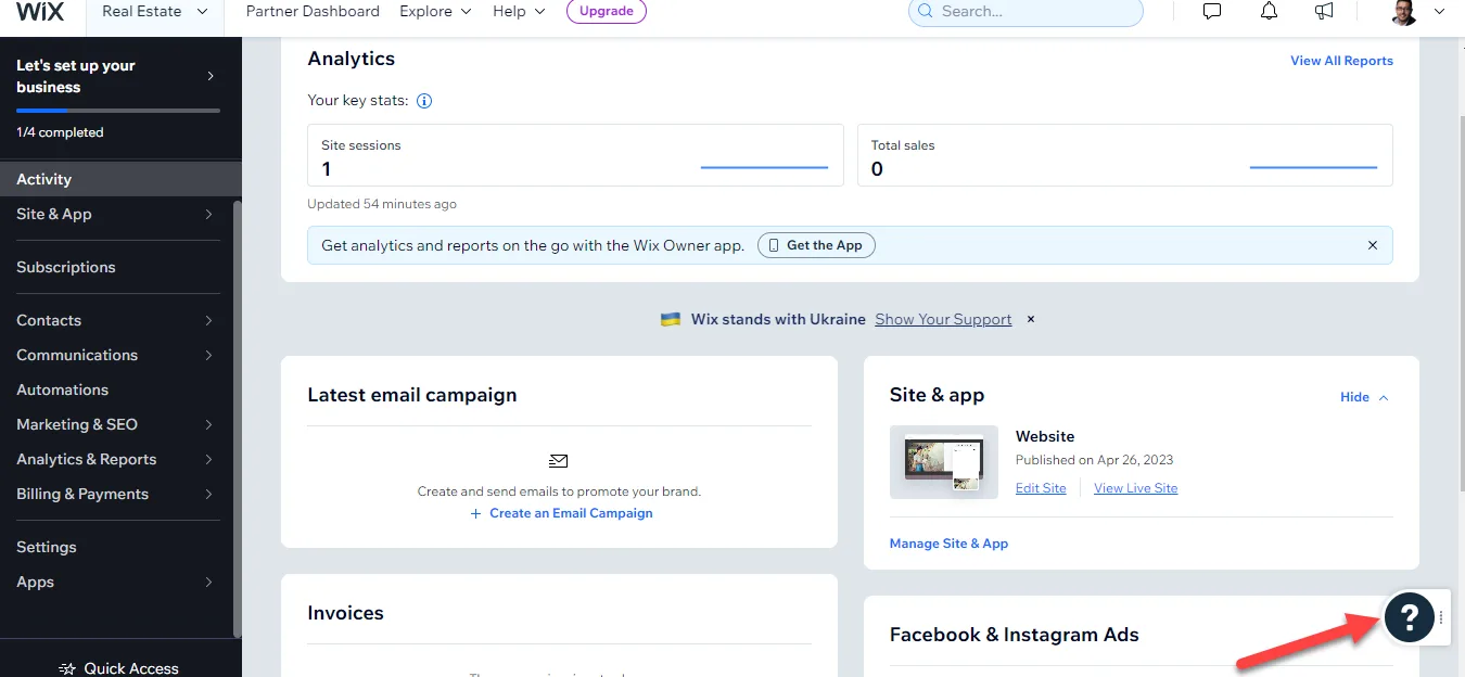 Wix site dashboard showing analytics and site panels, with a red arrow pointing to the round question mark help button in the bottom right
